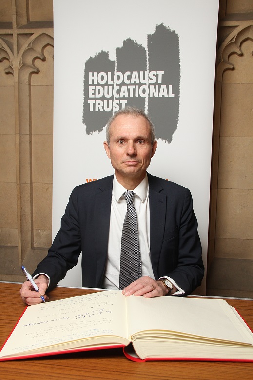 David signs the Holocause Educational Trust Book of Commitment